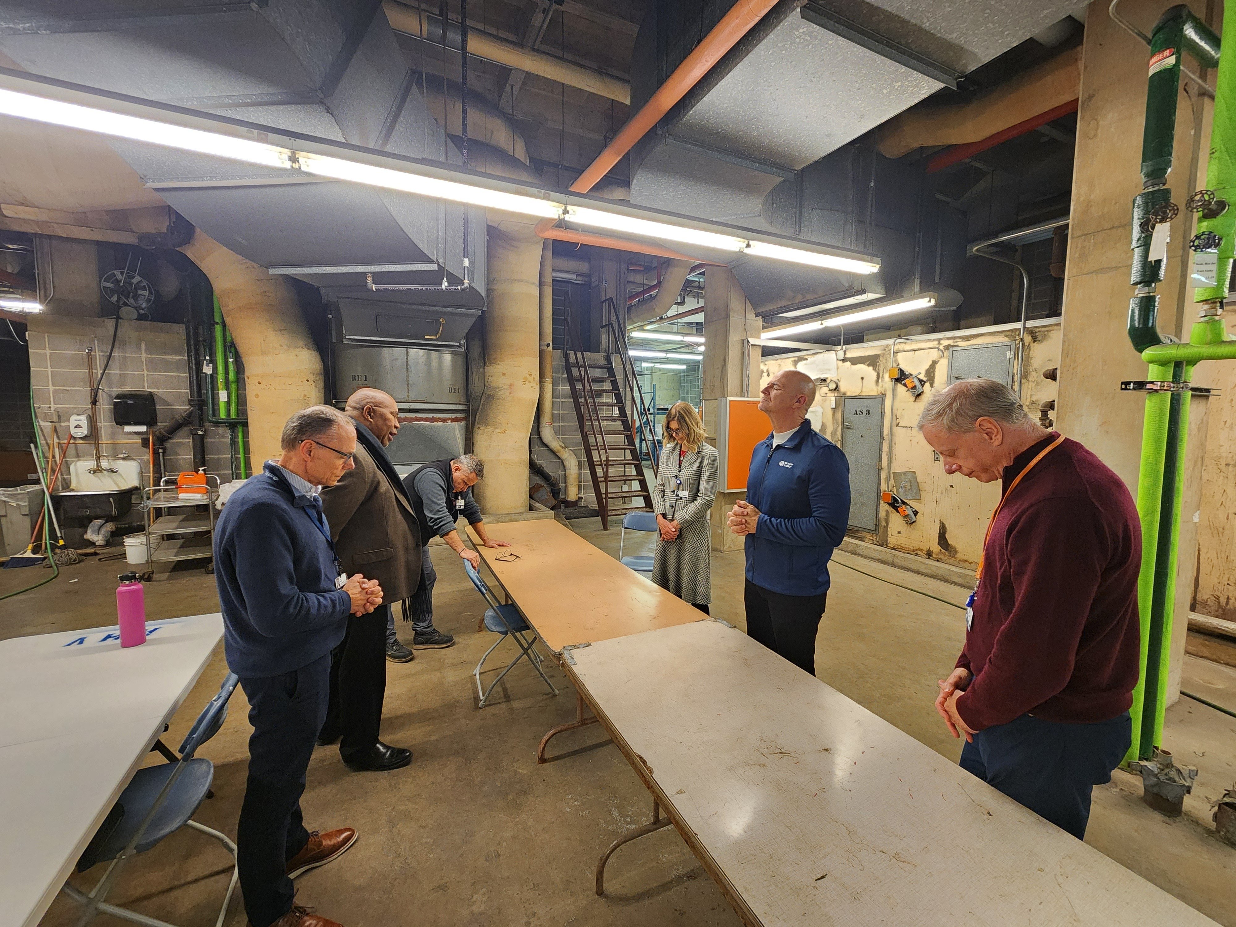 Moody leadership and other team members took time at the beginning of the construction project to pray over the plans and upcoming work.