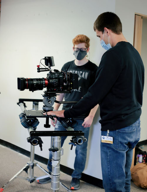 Communications major and senior, Jonah Oehler, helped get camera equipment set up and adjusted on set.