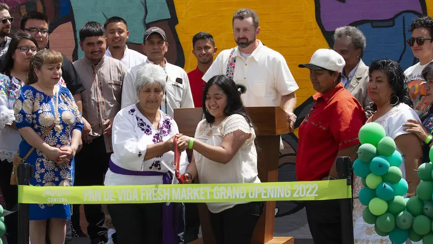 A group of people at a ribbon cutting ceremony. 